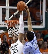 Miami's Kenny Kadji (35) rejects a shot by North Carolina forward James Michael McAdoo (43) during the first half of an NCCA college basketball game, Saturday, Feb. 9, 2013, in Coral Gables, Fla. (AP Photo/Wilfredo Lee)