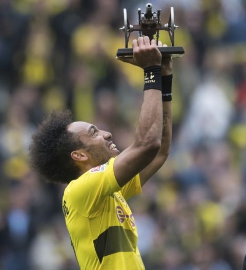Dortmund's Pierre-Emerick Aubameyang holds the best scorer trophy after the German Bundesliga soccer match between Borussia Dortmund and SV Werder Bremen in Dortmund, Germany Saturday, May 20, 2017.  (Bernd Thissen/dpa via AP)