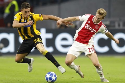 Ajax's Frenkie de Jong, right, and AEK's Ezequiel Ponce vie for the ball during a Group E Champions League soccer match between Ajax and AEK at the Johan Cruyff ArenA in Amsterdam, Netherlands, Wednesday, Sept. 19, 2018. (AP Photo/Peter Dejong)