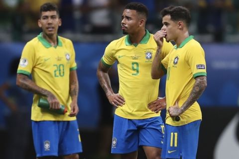 Brazil's Gabriel Jesus, center, waits for the referee to decide on the validity of his goal with teammates Roberto Firmino, left, and Philippe Coutinho, right, during a Copa America Group A soccer match at the Arena Fonte Nova in Salvador, Brazil, Tuesday, June 18, 2019. Referee Julio Bascunan, not in picture, annulled Gabriel Jesus' goal due to an offside position. Firmino and Coutinho also had goals disallowed during the match. (AP Photo/Natacha Pisarenko)