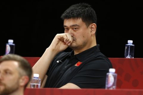 FILE - In this Sept. 4, 2019, file photo, Yao Ming, head of the Chinese Basketball Association and former NBA player, watches as China and Venezeula compete during their group phase basketball game in the FIBA Basketball World Cup at the Cadillac Arena in Beijing. Yao is now president of the Chinese Basketball Association, which announced over the weekend it is suspending its ties with the Rockets in retaliation for Houston Rockets general manager Daryl Morey's tweet that showed support for Hong Kong anti-government protesters. (AP Photo/Mark Schiefelbein, File)