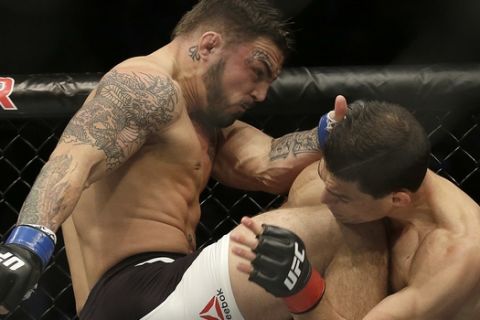 Mike Perry, left, knees Alan Jouban during the first round of a UFC Fight Night mixed martial arts fight in Sacramento, Calif., Saturday, Dec. 17, 2016. Jouban won by unanimous decision. (AP Photo/Jeff Chiu)