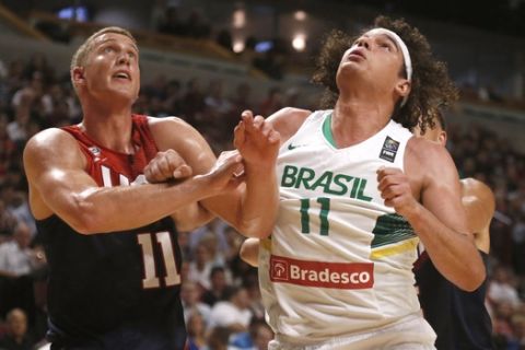 United States' Mason Plumlee (11), of the Brooklyn Nets and Brazil's Anderson Varejao, of the Cleveland Cavaliers,  battle for a rebound during the second half of an exhibition game between the US and Brazilian national teams Saturday, Aug. 16, 2014, in Chicago. The United States won 95-78. (AP Photo/Charles Rex Arbogast)