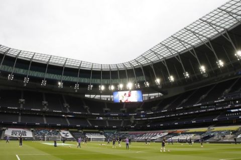Players warm up ahead of the English Premier League soccer match between Tottenham Hotspur and Manchester United at Tottenham Hotspur Stadium in London, England, Friday, June 19, 2020. (AP Photo/Matt Childs, Pool)