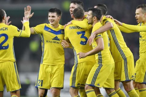 BATE's Nemanja Milunovic, center , is celebrated after scoring his side's first goal during a Group H Europa League soccer match between 1. FC Cologne and BATE Borisov in Cologne, Thursday, Nov. 2, 2017. (AP Photo/Martin Meissner)