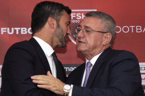 Former AC Milan and Roma defender Christian Panucci, left, shakes hands with Albanian Football Federation head Armand Duka during a news conference in Tirana, Albania. Wednesday, July 19, 2017. Panucci was announced as the new head of the national soccer team (AP Photo/Hektor Pustina)