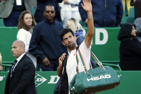 Serbia's Novak Djokovic waves after losing against Belgium's David Goffin, during their quarterfinal match of the Monte Carlo Tennis Masters tournament in Monaco, Friday, April, 21, 2017. (AP Photo/Claude Paris)