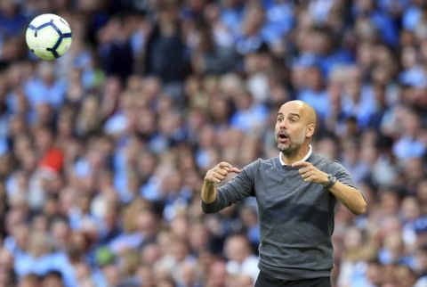 Manchester City coach Pep Guardiola gestures during the English Premier League soccer match between Manchester City and Newcastle United at the Etihad Stadium in Manchester, England, Saturday, Sept. 1, 2018. (AP Photo/Jon Super)