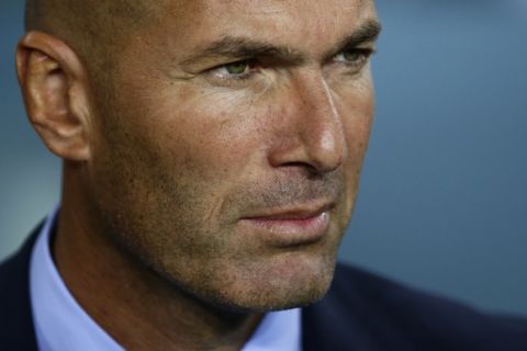 Real Madrid's head coach Zinedine Zidane awaits the start of the Spanish Supercup, first leg, soccer match between FC Barcelona and Real Madrid at the Camp Nou stadium in Barcelona, Spain, Sunday, Aug. 13, 2017. (AP Photo/Manu Fernandez)