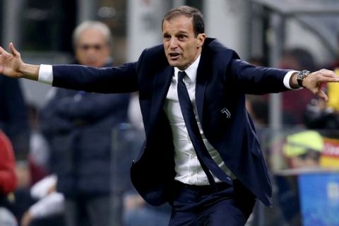 Juventus coach Massimiliano Allegri gestures to his players from the sidelines during a Serie A soccer match between AC Milan and Juventus, at the Milan San Siro stadium, Italy, Saturday, Oct. 28, 2017. (AP Photo/Antonio Calanni)
