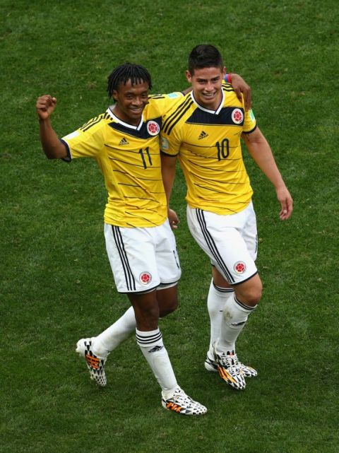 BRASILIA, BRAZIL - JUNE 19:  Juan Guillermo Cuadrado and James Rodriguez of Colombia celebrates after scoring his team's first goal during the 2014 FIFA World Cup Brazil Group C match between Colombia and Cote D'Ivoire at Estadio Nacional on June 19, 2014 in Brasilia, Brazil.  (Photo by Adam Pretty/Getty Images)