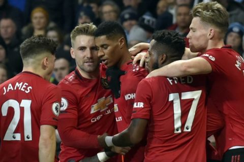 Manchester United's Marcus Rashford, center, celebrates with teammates after scoring his side's opening goal from the penalty spot during the English Premier League soccer match between Manchester City and Manchester United at Etihad stadium in Manchester, England, Saturday, Dec. 7, 2019. (AP Photo/Rui Vieira)