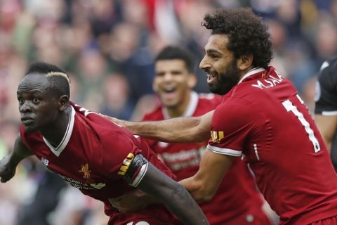 Liverpool's Sadio Mane celebrates scoring his side's first goal of the game, during the English Premier League soccer match between Liverpool and Crystal Palace, at Anfield, in Liverpool, England, Saturday Aug. 19, 2017. (Martin Rickett/PA via AP)