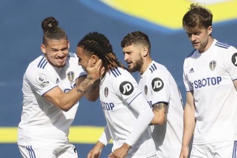Leeds United's Helder Costa, front celebrates with teammates after scoring his side's opening goal during the English Premier League soccer match between Leeds United and Fulham at Elland Road Stadium, in Leeds, England, Saturday, Sept. 19, 2020. (Carl Recine/Pool via AP)