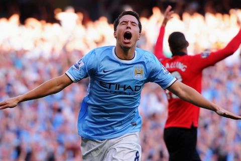 MANCHESTER, ENGLAND - SEPTEMBER 22:  Samir Nasri of Manchester City celebrates as he scores their fourth goal during the Barclays Premier League match between Manchester City and Manchester United at the Etihad Stadium on September 22, 2013 in Manchester, England.  (Photo by Michael Regan/Getty Images)