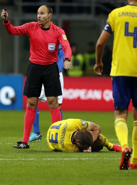 Sweden's Jakob Johansson lies on the pitch in pain during the World Cup qualifying play-off second leg soccer match between Italy and Sweden, at the Milan San Siro stadium, Italy, Monday, Nov. 13, 2017. (AP Photo/Antonio Calanni)