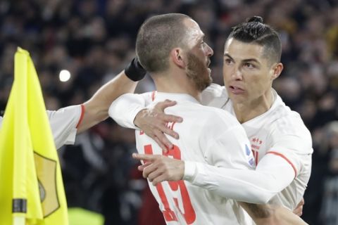 Juventus' Cristiano Ronaldo, right, celebrates with teammate Leonardo Bonucci after scoring his side's second goal during the Serie A soccer match between Roma and Juventus at the Rome Olympic Stadium, Italy, Sunday, Jan. 12, 2020. (AP Photo/Andrew Medichini)