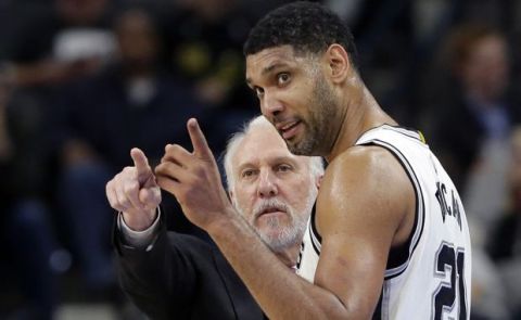 FILE - In this Dec. 2, 2015, file photo, San Antonio Spurs head coach Gregg Popovich, left, talks with forward Tim Duncan (21) during the second half of an NBA basketball game against the Milwaukee Bucks in San Antonio. They were joined at the hip for 19 years, a player and coach combination that enjoyed more wins than any in NBA history. And now that Duncan's playing days are done, Popovich is about to start anew in some respects.  (AP Photo/Eric Gay, File0