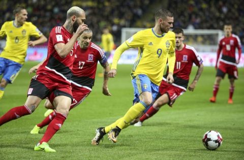 Sweden's Marcus Berg, right, is challenged by Luxembuourgs Dwayn Holter, left, and Mario Mutsch during the World Cup 2018 group A qualifying match between Sweden and Luxembourg at Friends Arena in Solna, Stockholm, Saturday Oct. 7, 2017. (Soren Andersson/TT via AP)