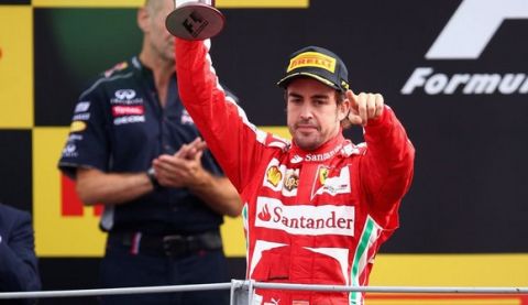 MONZA, ITALY - SEPTEMBER 08:  Fernando Alonso of Spain and Ferrari celebrates on the podium after finishing second during the Italian Formula One Grand Prix at Autodromo di Monza on September 8, 2013 in Monza, Italy.  (Photo by Paul Gilham/Getty Images)