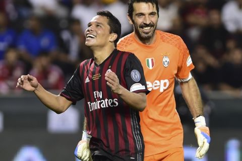 AC Milan's Carlos Bacca, left, stands by Juventus goalkeeper Gianluigi Buffon after missing a scoring chance during the Italian Super Cup soccer match between Juventus and AC Milan, at the Al Sadd Sports Club in Doha, Qatar, Friday, Dec. 23, 2016. (AP Photo/Alexandra Panagiotidou)
