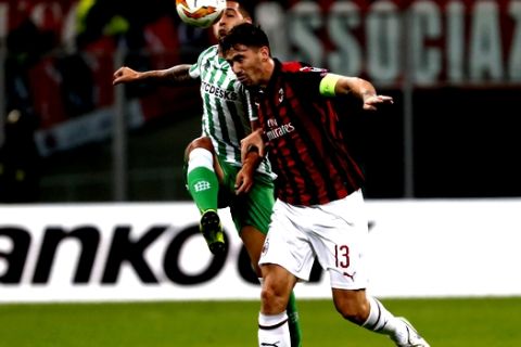 AC Milan's Alessio Romagnoli, right, and Betis' Sergio Leon vie for the ball during the Europa League, Group F soccer match between AC Milan and Betis, at the San Siro Stadium in Milan, Italy, Thursday, Oct. 25, 2018. (AP Photo/Antonio Calanni)