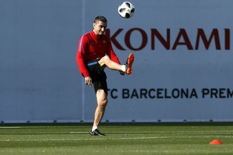 FC Barcelona's coach Ernesto Valverde kicks the ball during a training session at the Sports Center FC Barcelona Joan Gamper in Sant Joan Despi, Spain, Friday, April 20, 2018. Sevilla will play against FC Barcelona in the Spanish Copa del Rey soccer final on Saturday. (AP Photo/Manu Fernandez)