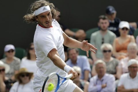 Stefanos Tsitsipas of Greece returns to Italy's Thomas Fabbiano in a Men's singles match during day one of the Wimbledon Tennis Championships in London, Monday, July 1, 2019. (AP Photo/Ben Curtis)
