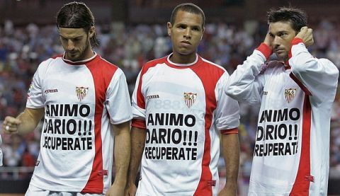 Sevilla's Aitor Ocio, left, Luis Fabiano, centre and Jose Marti line up with messages of support for former Sevilla player Dario Silva, before their first round, second leg, UEFA Cup soccer match against Atromitos at the Ramon Sanchez Pizjuan stadium in Seville, Spain Thursday Sept. 28, 2006. Dario Silva has a leg amputated after a car crash in Uruguay. Message on shirts read: "Cheer up Dario, You Recover" (AP Photo/Javier Barbancho)