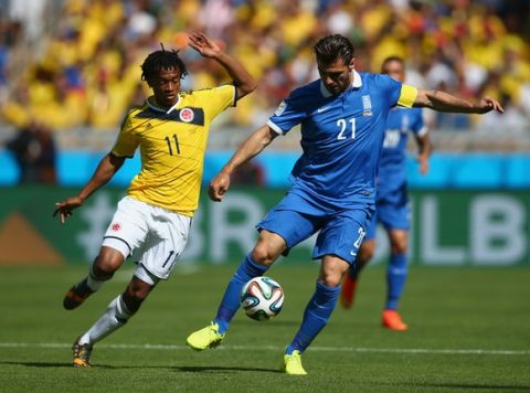 BELO HORIZONTE, BRAZIL - JUNE 14: Konstantinos Katsouranis of Greece controls the ball against Juan Guillermo Cuadrado of Colombia during the 2014 FIFA World Cup Brazil Group C match between Colombia and Greece at Estadio Mineirao on June 14, 2014 in Belo Horizonte, Brazil.  (Photo by Paul Gilham/Getty Images)