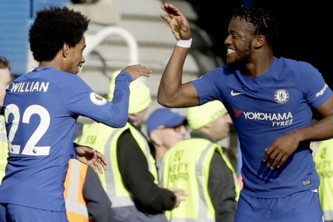 Chelsea's Michy Batshuayi, right, celebrates scoring his side's fourth goal with Chelsea's Willian during the English Premier League soccer match between Chelsea and Watford at Stamford Bridge stadium in London, Saturday, Oct. 21, 2017. (AP Photo/Matt Dunham)