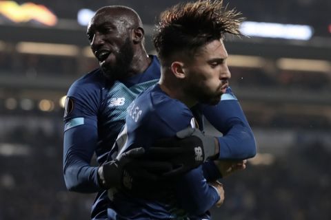Porto's Moussa Marega, left, and Alex Telles celebrate their opening goal during the Europa League group G soccer match between FC Porto and Feyenoord at the Dragao stadium in Porto, Portugal, Thursday, Dec. 12, 2019. (AP Photo/Miguel Angelo Pereira)