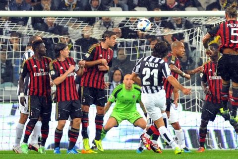 Juventus midfielder Andrea Pirlo, back to camera center, scores during a Serie A soccer match between Juventus and AC Milan at the Juventus stadium, in Turin, Italy, Sunday, Oct. 6, 2013. (AP Photo/Massimo Pinca)