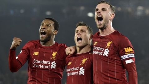 Liverpool's Georginio Wijnaldum, left, Liverpool's James Milner, centre, and Liverpool's Jordan Henderson celebrate during the English Premier League soccer match between Wolverhampton Wanderers and Manchester City at the Molineux Stadium in Wolverhampton, England, Friday, Dec. 27, 2019. (AP Photo/Rui Vieira)