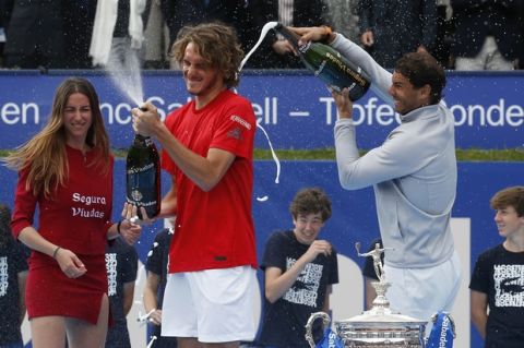 Spain's Rafael Nadal, right, pours sparkling wine on Greece's Stefanos Tsitsipas after winning the Barcelona Open Tennis Tournament final in Barcelona, Spain, Sunday, April 29, 2018. Nadal defeated Greece's Stefanos Tsitsipas 6-2, 6-1 in the final. (AP Photo/Manu Fernandez)
