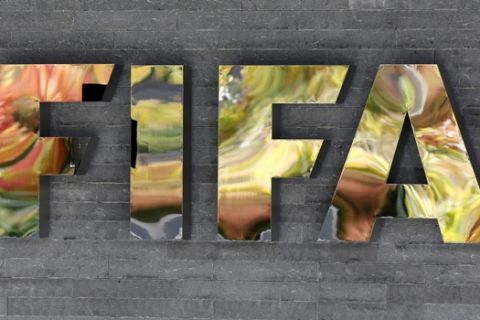 FILE - In this Sept. 25, 2015 file picture the FIFA logo is  pictured on a wall of the FIFA headquarters during a meeting of the FIFA Executive Committee in Zurich, Switzerland  while autumnal colors reflecting .  FIFA's ethics committee has asked for sanctions against Sepp Blatter and Michel Platini after finishing investigations into their alleged financial wrongdoing. FIFA President Blatter and UEFA President Platini now face bans of several years at full hearings before FIFA ethics judge Joachim Eckert, likely in December.  . (AP Photo/Michael Probst)