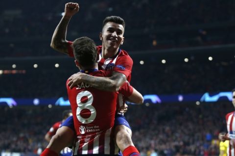 Atletico Saul Niguez celebrates with his teammate Atletico Angel Correa after scoring his side's opening goal opening goal during the Group A Champions League soccer match between Atletico Madrid and Borussia Dortmund at Wanda Metropolitano stadium in Madrid, Spain, Tuesday, Nov. 6, 2018. (AP Photo/Paul White)