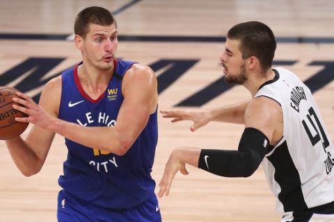 Denver Nuggets center Nikola Jokic (15) is defended by Los Angeles Clippers' center Ivica Zubac (40) during the second half of an NBA basketball game Wednesday, Aug. 12, 2020, in Lake Buena Vista, Fla. (Kim Klement/Pool Photo via AP)