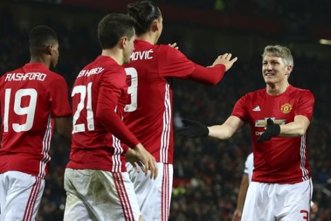 Manchester United's Zlatan Ibrahimovic, third left is congratulated by teammate Manchester United's Bastian Schweinsteiger, second right, after he scored his sides 4th goal and his second of the game during the English League Cup quarterfinal soccer match between Manchester United and West Ham United at Old Trafford in Manchester, England Wednesday, Nov. 30, 2016. Man. United won the match 4-1. (AP Photo/Dave Thompson)