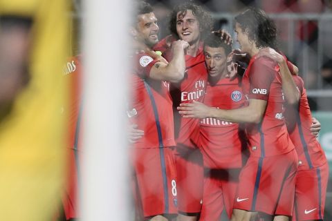 Paris Saint Germain's forward Angel Di Maria, center, celebrates with teammates after scoring the second goal during his French League One soccer match against Angers, in Angers, western France, Friday, April 14, 2017. Paris won 2-0. (AP Photo/David Vincent)