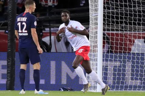 Reims' Boulaye Dia, center, celebrates after scoring his side's second goal during the French League One soccer match between PSG and Reims at the Parc des Princes stadium in Paris, Wednesday, Sept. 25, 2019. (AP Photo/Michel Euler)