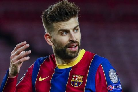 Barcelona's Gerard Pique reacts during the Champions League round of 16, first leg soccer match between FC Barcelona and Paris Saint-Germain at the Camp Nou stadium in Barcelona, Spain, Tuesday, Feb. 16, 2021. (AP Photo/Joan Monfort)