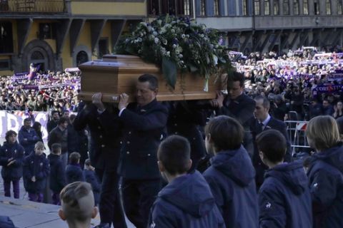 The coffin is carried into the church during the funeral ceremony of Italian player Davide Astori in Florence, Italy, Thursday, March 8, 2018. The 31-year-old Astori was found dead in his hotel room on Sunday after a suspected cardiac arrest before his team was set to play an Italian league match at Udinese. (AP Photo/Alessandra Tarantino)