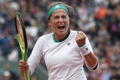 Latvia's Jelena Ostapenko clenches her fist after scoring a point against Denmark's Caroline Wozniacki during their quarterfinal match of the French Open tennis tournament at the Roland Garros stadium, in Paris, France. Tuesday, June 6, 2017. (AP Photo/Petr David Josek)