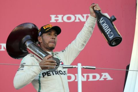 Race winner Mercedes driver Lewis Hamilton celebrates on the podium at the Japanese Formula One Grand Prix at the Suzuka Circuit in Suzuka, central Japan, Sunday, Oct. 7, 2018. (AP Photo/Ng Han Guan)