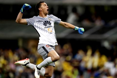 America goalkeeper Agustin Marchesin celebrates after his teammate Cecilio Dominguez scores their side second goal against Cruz Azul during a Mexico soccer league match in Mexico City, Saturday, March 31, 2018. (AP Photo/Eduardo Verdugo)