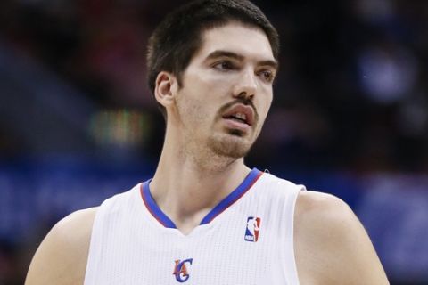 Los Angeles Clippers' Byron Mullens runs down the court against the Orlando Magic during the second half of an NBA basketball game in Los Angeles, Monday, Jan. 6, 2014. The Clippers won 101-81. (AP Photo/Danny Moloshok)