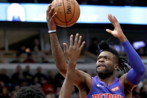 Detroit Pistons guard Reggie Bullock, right, drives to the basket against Chicago Bulls forward Justin Holiday during the first half of an NBA basketball game Saturday, Oct. 20, 2018, in Chicago. (AP Photo/Nam Y. Huh)