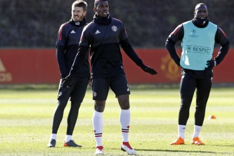 Manchester United's Paul Pogba, foreground center, attends a training session ahead of Wednesday's Champions League, round of 16 first-leg soccer match against Sevilla, at the AON Training Complex, Carrington, England, Tuesday, Feb. 20, 2018.  (Martin Rickett/PA via AP)