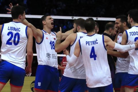 Serbia's Marko Podrascanin, second left, jubilates with teammates after they won the men's European Volleyball Championship semi final match between Serbia and France at the the AccorHotels Arena in Paris, Friday, Sept. 27, 2019. (AP Photo/Michel Euler)